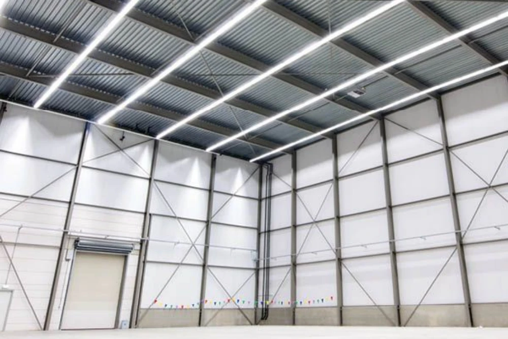 Cold white linear lights in a warehouse.